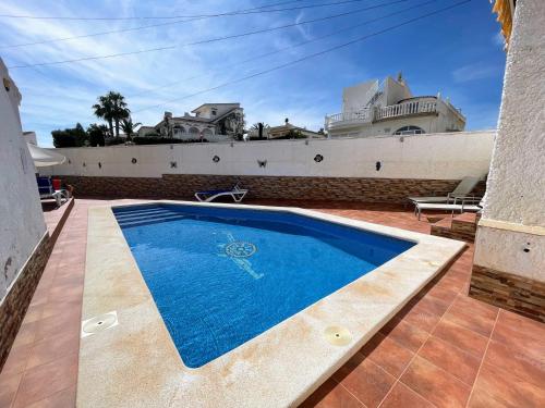 a swimming pool in the middle of a house at Traditional Villa with Private Pool SM591 in San Miguel de Salinas