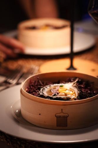 a bowl of food on a plate on a table at Hotel Fariones in Puerto del Carmen