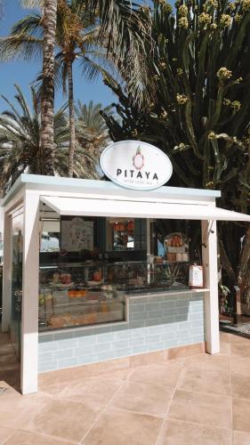 a pizza shop with a sign on top of it at Hotel Fariones in Puerto del Carmen