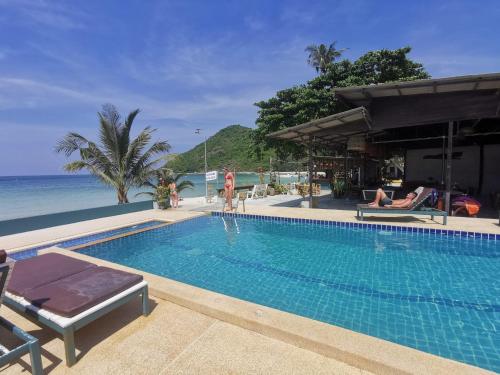 a swimming pool with a view of the ocean at Thong Nai Pan Beach Resort in Thong Nai Pan Yai