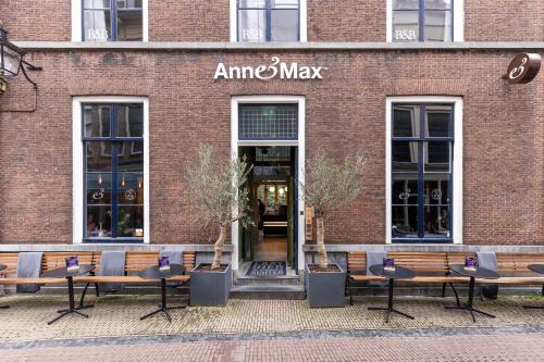 a brick building with benches in front of a store at B&B Utrecht Domkwartier in Utrecht