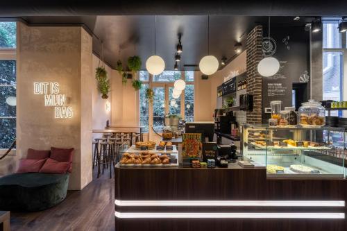 a bakery with a counter with a bunch of pastries at B&B Utrecht Domkwartier in Utrecht