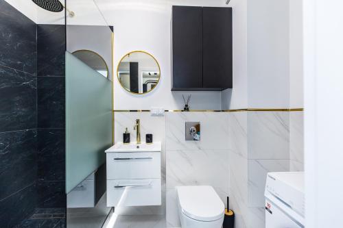 een badkamer met een wit toilet en een spiegel bij Cloud9 - Barska 69 in Krakau