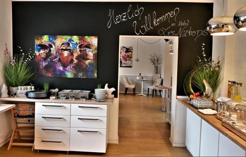 a kitchen with a large painting on the wall at Les Nations in Berlin
