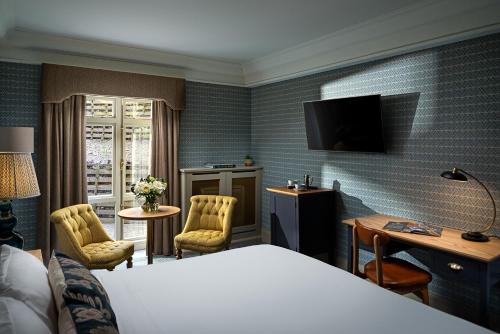 a hotel room with a bed and a television at Schoolhouse Hotel in Dublin