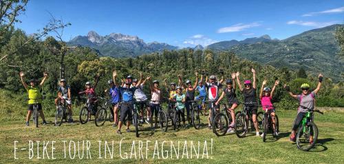 a group of people on bikes with their hands in the air at Villa Belvedere in Pieve Fosciana