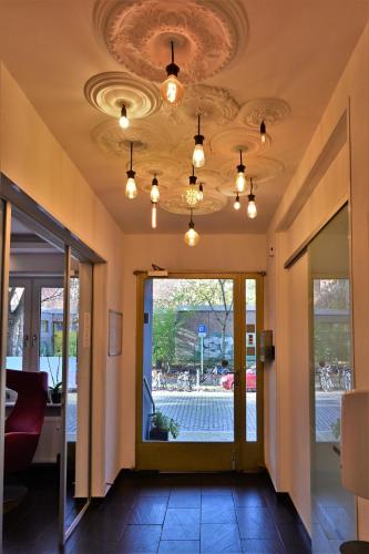 an office lobby with a ceiling with lights at Les Nations in Berlin