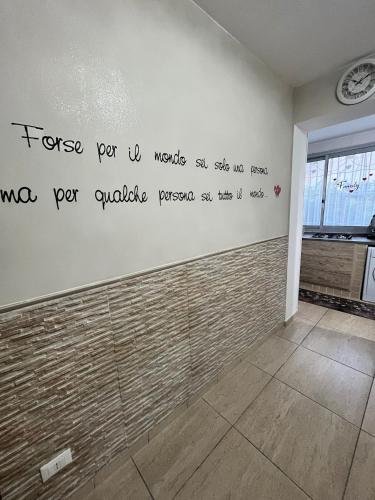 a room with a wall with writing on the wall at House del corso in Palermo