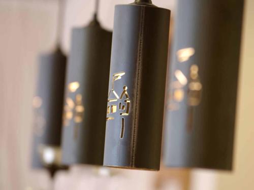 a row of black books hanging on a wall at Da`Sporrer Hotel & Wirtshaus in Neunburg vorm Wald