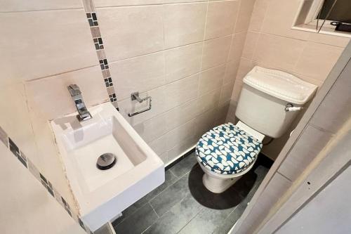 a bathroom with a toilet and a sink at Chelwood Residence in Moortown