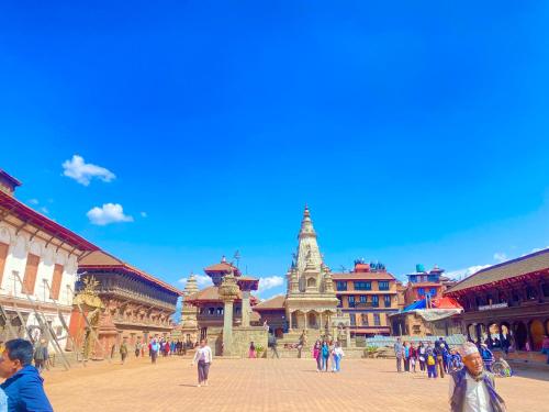 a group of people walking around a city at Shiva Guest House in Bhaktapur