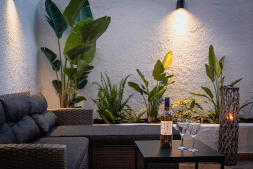 a living room with a couch and two wine glasses on a table at Old Town Villa in Rhodes Town