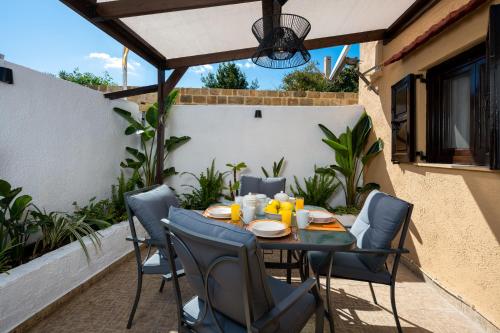 a patio with a table and chairs on a balcony at Old Town Villa in Rhodes Town