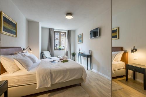 a hotel room with a bed and a desk at Leonis Restaurant & Rooms in Split