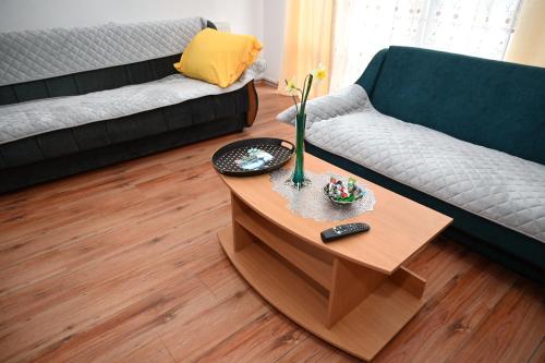 a living room with a couch and a coffee table at Apartman Sena in Laktaši