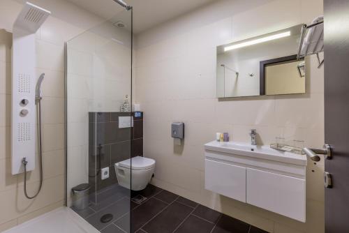 a bathroom with a shower and a toilet and a sink at Leonis Restaurant & Rooms in Split