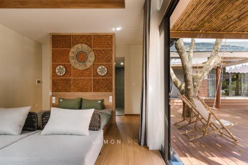 a bedroom with a bed and a wooden floor at LaMon House - Venuestay in Hòa Bình