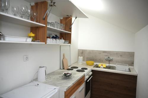a small kitchen with a stove and a sink at Apartman Sena in Laktaši