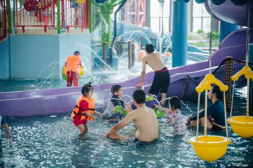 a group of people playing in the water at a water park at Da Nang - Mikazuki Japanese Resorts & Spa in Da Nang