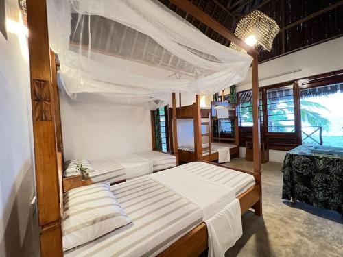 a bedroom with two beds in a room at Lui Ushongo Beach House in Pangani