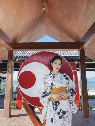 a woman in a kimono sitting on a chair at Da Nang - Mikazuki Japanese Resorts & Spa in Da Nang