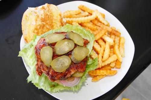 a plate of food with a sandwich and french fries at SleepOver Orpen Gate in Acornhoek