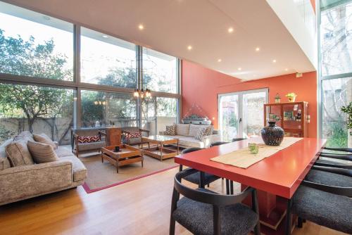 a living room with a red table and chairs at Villa Amaryllis in Athens