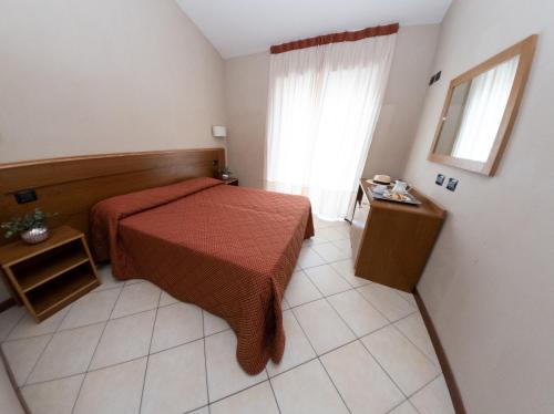 a bedroom with a red bed and a window at Country House Elite in Cascia