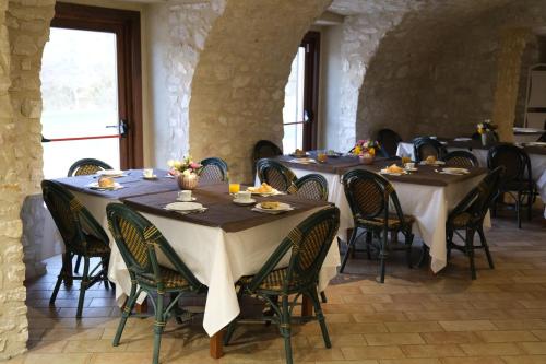 a dining room with tables and chairs in a building at Country House Elite in Cascia