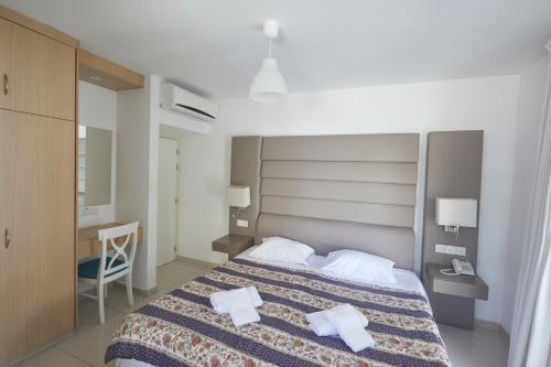 a bedroom with a bed with two towels on it at Napa Nest in Ayia Napa