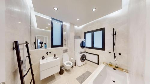 a bathroom with a toilet and a sink and a shower at SERENE - Infinity Cview pool - 4 bedrooms Luxury Penthouse in Haifa