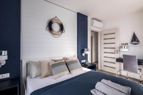 a bedroom with a bed and a mirror on the wall at Balatonic Sky in Zamárdi
