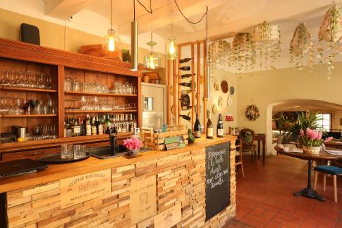 a bar in a restaurant with a counter at La Treille Muscate in Cliousclat