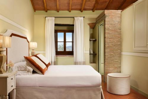 a bedroom with a large white bed and a window at Borgo Antico Casalbosco Holiday Home & Winery in Santomato 