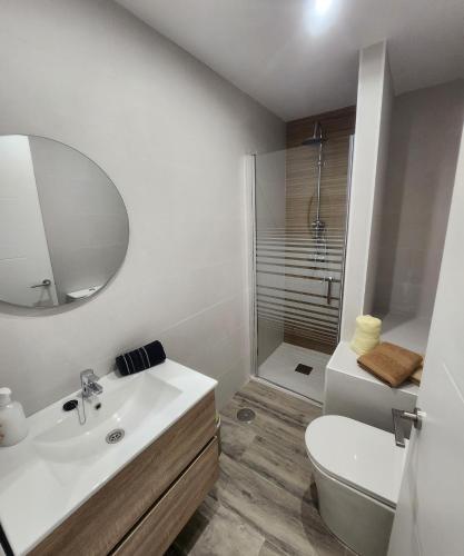 uma casa de banho com um lavatório, um WC e um espelho. em Green Apartamentos Cartagena em Cartagena