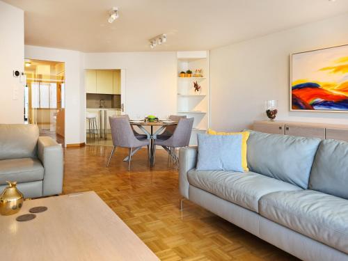 a living room with a couch and a table at Hotel Restaurant Steenhuyse in Oudenaarde