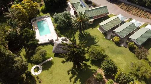 an aerial view of a yard with a swimming pool at Neat standard room in guesthouse - 2088 in Bulawayo