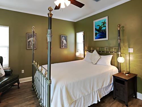 a bedroom with a large bed and a chair at Turtle Creek #A in Orange Beach