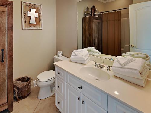 a bathroom with a white sink and a toilet at Turtle Creek #A in Orange Beach