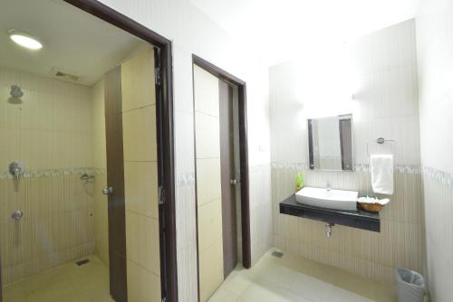 a bathroom with a sink and a shower at SRM Hotel in Tuticorin