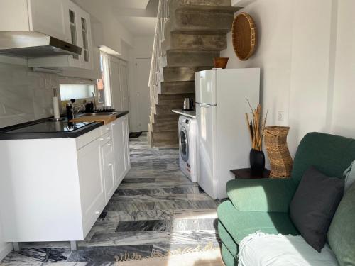 a kitchen and living room with a refrigerator and a couch at Lovers House in Setúbal