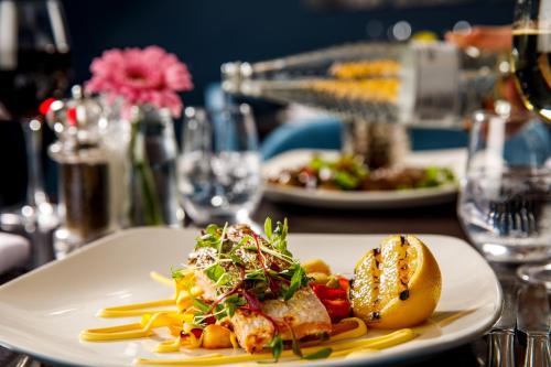 a white plate with food on a table at Mercure Swansea Hotel in Swansea