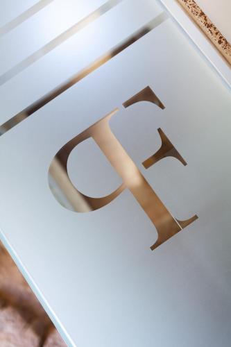 a glass window with a gold symbol on it at Palazzo Ferrucci Luxury Suites in Cagliari