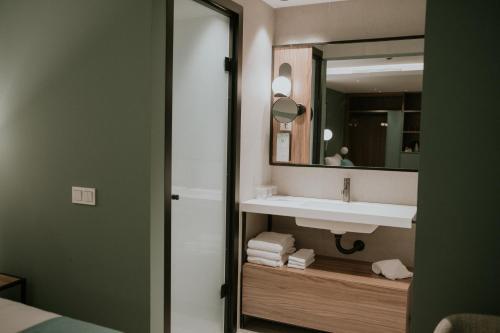 een badkamer met een wastafel en een spiegel bij Catalina Plaza Hotel Sostenible in Las Palmas de Gran Canaria