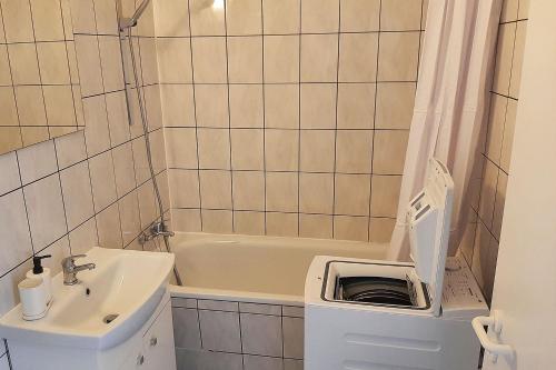 ein Badezimmer mit einem Waschbecken, einem WC und einer Badewanne in der Unterkunft Cozy apartments in Halle in Nietleben