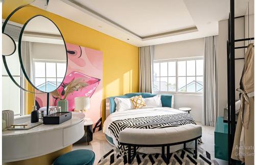 a bedroom with a bed and a large mirror at Novaworld Villas in Phan Thiet
