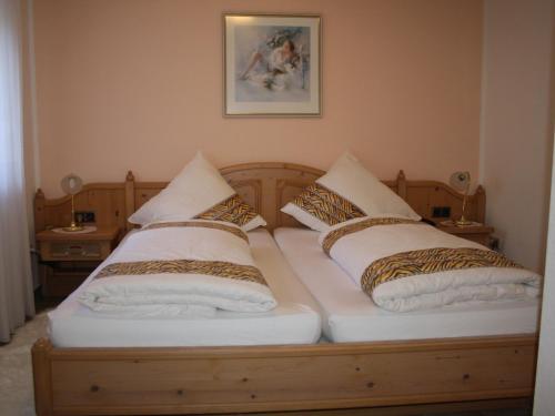 a bed with two pillows on top of it at FEWO Bilstein in Lennestadt