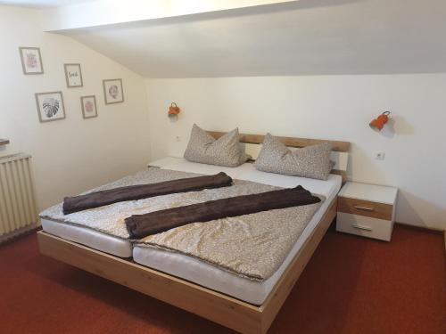 a bedroom with a bed with brown blankets on it at Ferienwohnung Flösserstube in Bichel