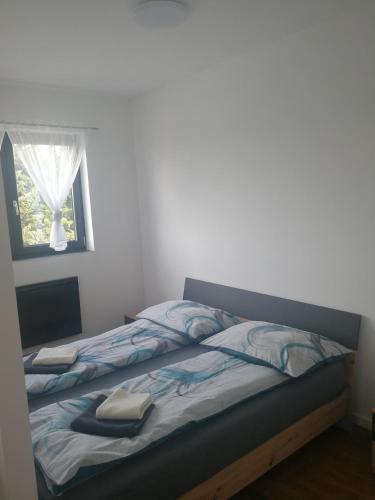 a bed in a bedroom with a window at Terec Haus in Bruckneudorf