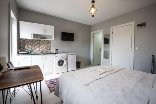 1 dormitorio con cama, mesa y cocina en Zelya İstanbul flats, en Estambul